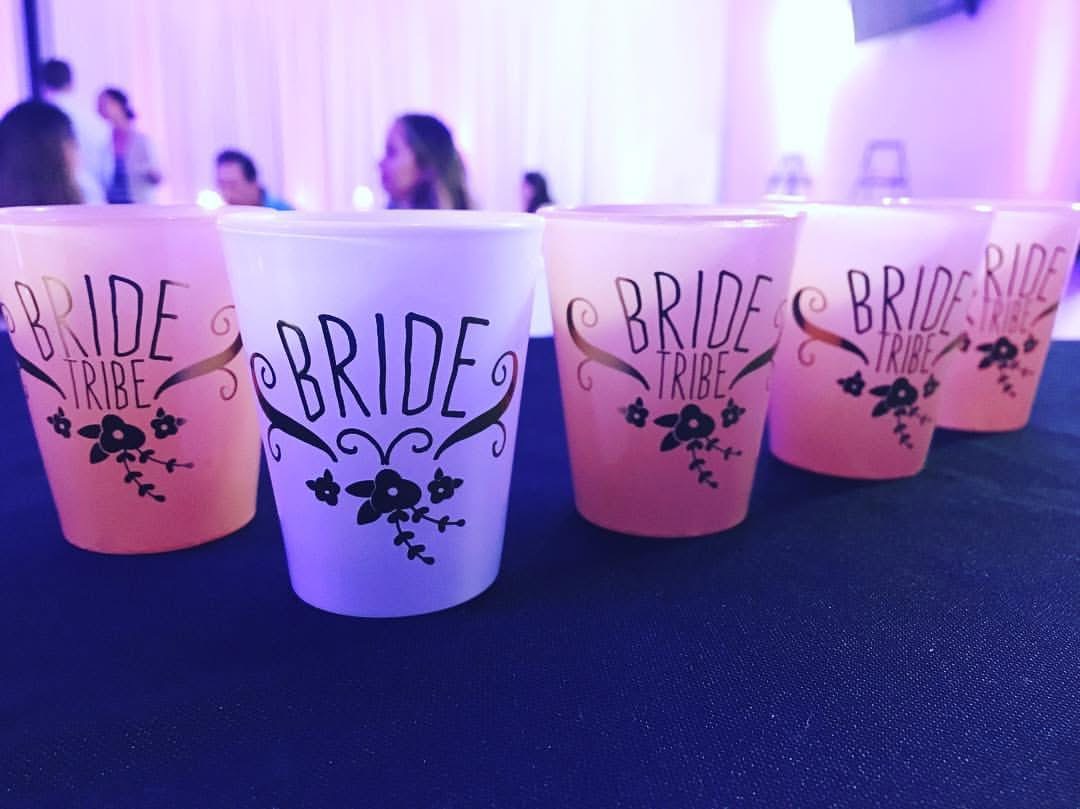 Custom Bride Tribe cups lined up on a bar at a wedding reception
