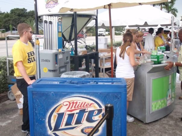 Outdoor festival beverage station with guests being served